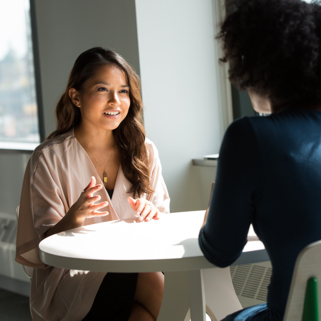 two woman talking about how to find a life and business coach and what to look for in a life and business coach